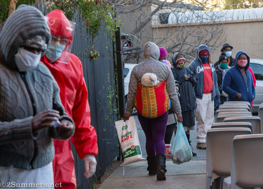 Lady leaving with her baby and food parcel