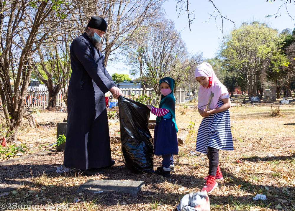 Kids working to clean up rubbish at the cemetery
