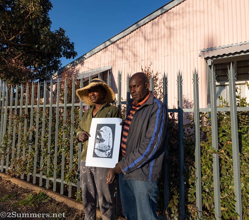 Alfred and Andile in front of the historic Brixton house that they painted.