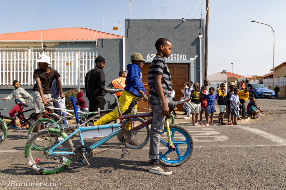 Cyclists from the Sentech Croozers and the Soweto Street Fighters get ready to ride in a warmup for the parade.