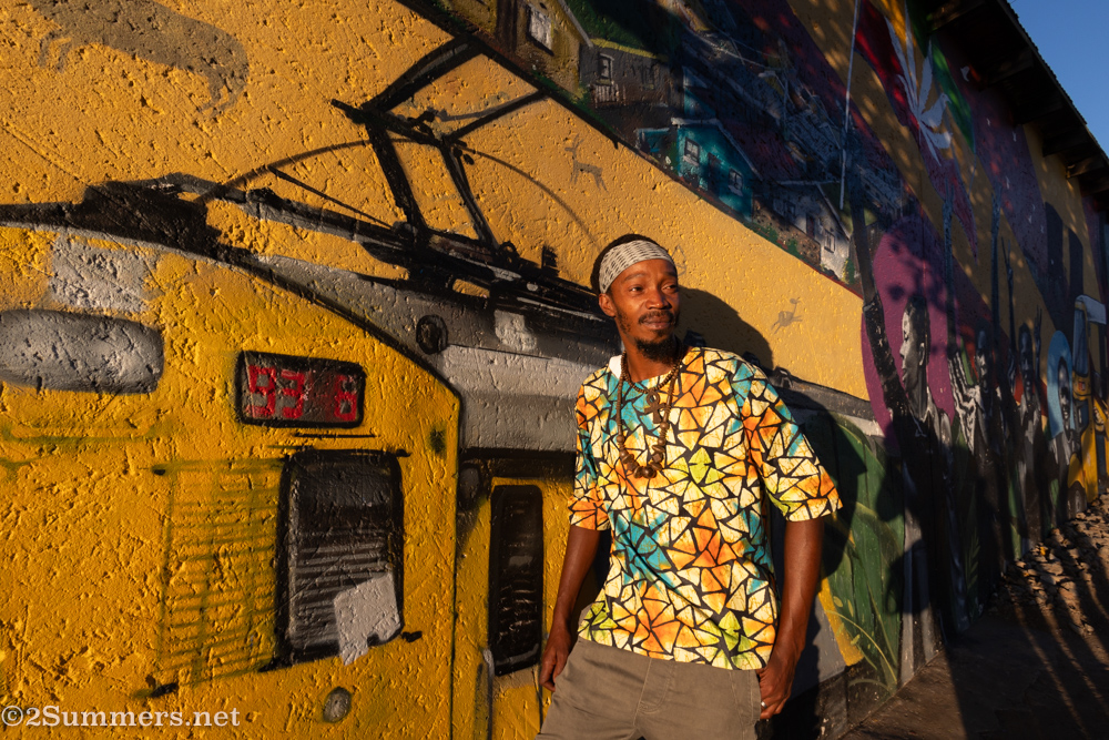 Tsepho from Lebo's in front of the mural