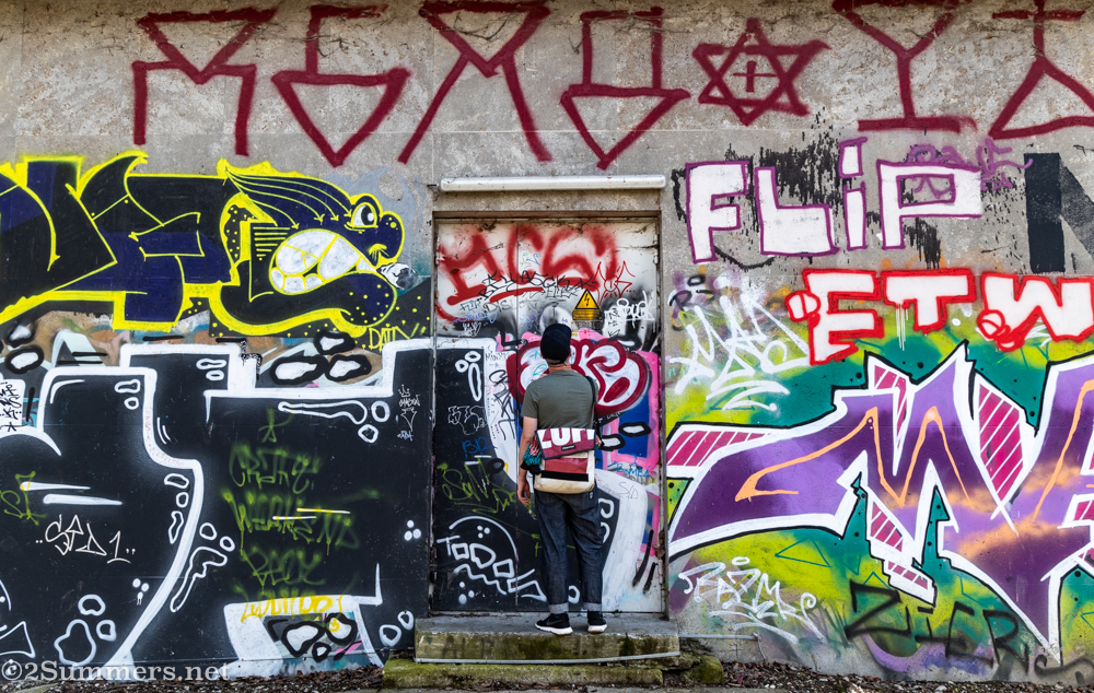 Thorsten peeling stickers from a building near the Isar River