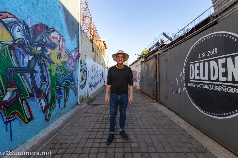 Thorsten standing in a Brixton alleyway, surrounded by graffiti